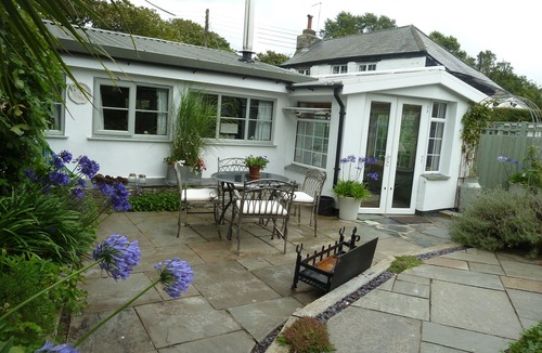 St Issey Cottage | Quirky home with romantic shepherds' hut bedrooms and pretty garden near Padstow